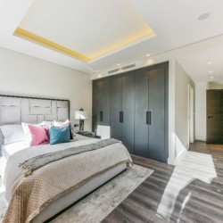 large bedroom with king size bed and fitted wardrobes, Holland Park Apartments, Kensington, London W14