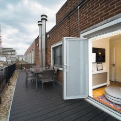 large balcony with dining table and view to living room, Bond Street Apartments, Mayfair, London W1