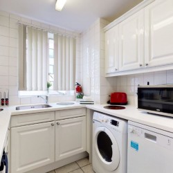 white kitchen with washer/dryer and dishwasher, Chesterfield Apartments, Mayfair, London W1