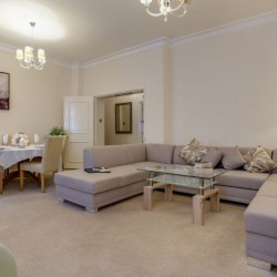 living room with large sofa, flowers, dinging area, Chesterfield Apartments, Mayfair, London W1