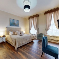 main bedroom with king size bed, chair, tv and wood floors, Chesterfield Apartments, Mayfair, London W1