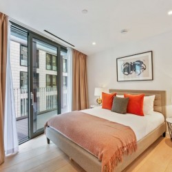 bedroom with balcony, double bed and side tables with lamps, The Residences, Southwark, London SE1