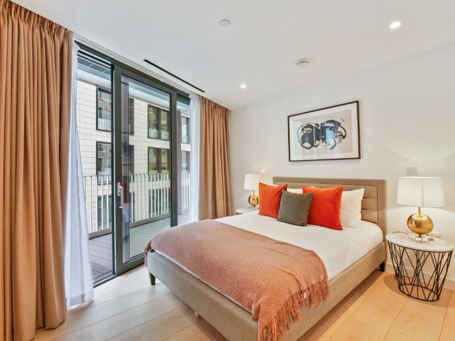 bedroom with balcony, double bed and side tables with lamps, The Residences, Southwark, London SE1