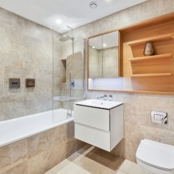 large modern bathroom with bathtub, shower, sink, mirror and shelves, The Residences, Southwark, London SE1