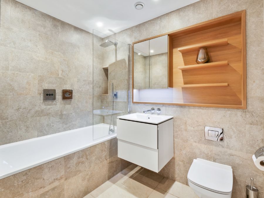 large modern bathroom with bathtub, shower, sink, mirror and shelves, The Residences, Southwark, London SE1