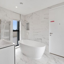 bathroom with free-standing bathtub, sink, towel rails, large door, 3 bedroom penthouse apartment