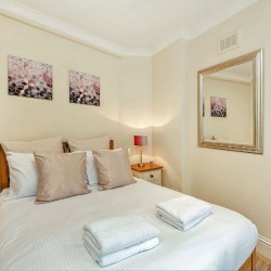 double bed with towels, Seven Dials Apartment, Covent Garden, London WC2
