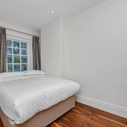 double bedroom with chest of drawers and side table, Portman Square Apartment, Marylebone, London W1