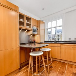 fully equipped kitchen with bar stools, Portman Square Apartment, Marylebone, London W1