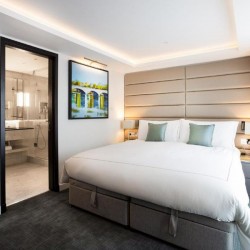 bedroom with king size bed and view to bathroom, The Luxury Apartments, Knightsbridge, London SW3