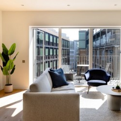 1 bedroom apartment living room with sofa, dining table and balcony, Natver Short let Apartments, Southwark, London SE1