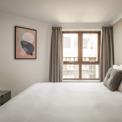 bedroom with king size bed, TV and art on wall, Kensington High Street, Kensington, London W8