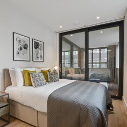 double bed, side table with lamp and in-door balcony, Fitzrovia Serviced Apartments, Fitzrovia, London W1