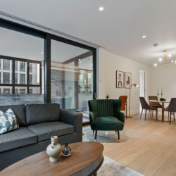 living area with oval table, sofa, chair, work desk and dining area, Fitzrovia Serviced Apartments, Fitzrovia, London W1