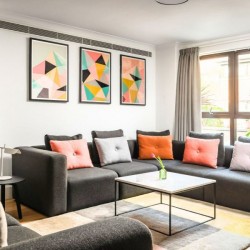 living room with large sofa, colourful cushions, wall art, 2 bedroom apartment