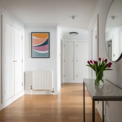 hallway with side table, flowers, mirror and wall print, 2 bedroom apartment