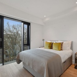 bedroom with double bed, side table with lamp and large window, Fitzrovia Serviced Apartments, Fitzrovia, London W1