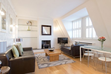 living room with 2 leather sofas, coffee table and dining area, Barrett Apartment, Marylebone, London W1