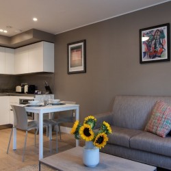 table with flowers, sofa, dining table and kitchen, Camden Town Apartments, Camden, London NW1