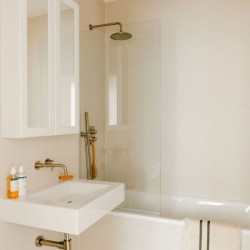 bathroom with sink, shower over bath tub and towel rail, The Deluxe Apartments, Marylebone, London W1