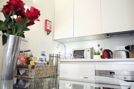 kitchen with roses and welcome pack, Liverpool Street Apartments, City, London EC2