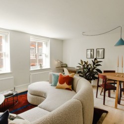 large sofa with pillows, coffee tables, dining table. plant and work desk, The Deluxe Apartments, Marylebone, London W1