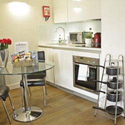 kitchen with glass dining table, pots, pans and work space, Liverpool Street Apartments, City, London EC2