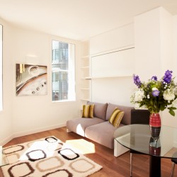 studio apartment with glass table and flowers, sofa, Liverpool Street Apartments, City, London EC2