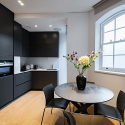 dining table with flowers and kitchen, Mornington Crescent, Camden, London NW1