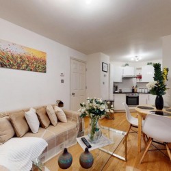 living area with sofa and cushions, glass table, dining table and kitchen, Piccadilly Circus, Soho, London SW1