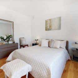 bedroom with double bed, stool, drawers and large mirror, Grosvenor Square Apartments, Mayfair, London W1