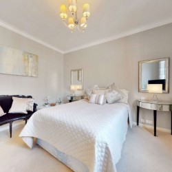 double bedroom with side sofa and mirror on wall, Grosvenor Square Apartments, Mayfair, London W1