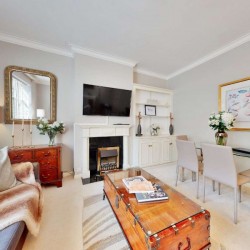 sofa bed, large trunk table, dining table, wall mounted tv and art, Grosvenor Square Apartments, Mayfair, London W1