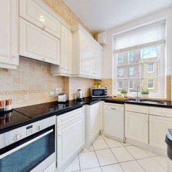 white kitchen with microwave and plants, Grosvenor Square Apartments, Mayfair, London W1