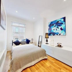 double bedroom with drawers and artwork, St James's Apartments, Mayfair, London SW1