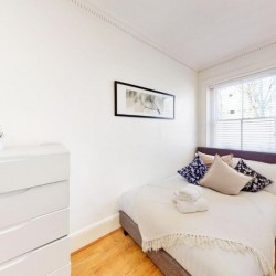 bedroom with double bed, chest of drawers and side table with lamp, St James's Apartments, Mayfair, London SW1