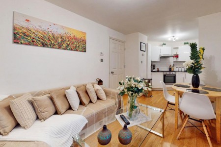 living room with sofa, wood floors, glass table and kitchen, Piccadilly Circus, Soho, London SW1