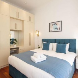 bedroom with double bed and large wardrobe, The Executive Apartments, Kensington, London W8