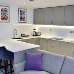 large kitchen with breakfast bar and sofa, St Johns Apartments, St Johns Wood, London NW8