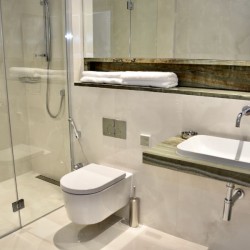 shower room with toilet, sink, large mirror and towels, St Johns Apartments, St Johns Wood, London NW8