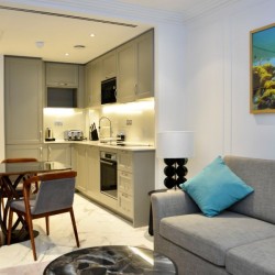 living room with sofa, art, dining set and kitchen, St Johns Apartments, St Johns Wood, London NW8