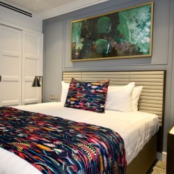 king size bed, large wardrobe, works of art and side table, St Johns Apartments, St Johns Wood, London NW8