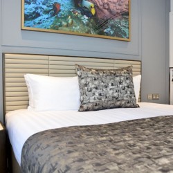 king size bed with side tables and colourful print on wall, St Johns Apartments, St Johns Wood, London NW8