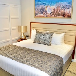 bedroom with king bed and large wardrobe, side tables with golden lamps, 2 bedroom super deluxe apartment