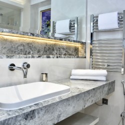 bathroom with large sink, towels and heated towel rail, St Johns Apartments, St Johns Wood, London NW8