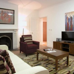 living room with sofa, table, chair, side table with tv, works of art on the walls, King's Apartments, City, London EC4