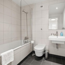 bathroom with tub, toilet, sink and mirror, Sir John's Apartments, City, London EC4