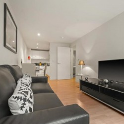 large leather sofa, side table with TV and kitchen, Sir John's Apartments, City, London EC4