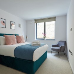 double bed, chair and wall mirror, The Mews Homes, Hammersmith, London W6