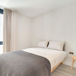 bedroom with double bed and small stool, Wembley Apartments, Wembley, London HA9
